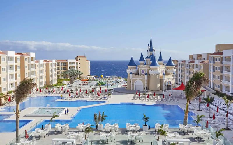 Castle-themed resort with a pool and ocean view.