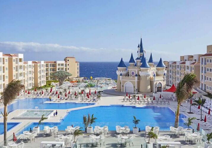 Castle-themed resort with a pool and ocean view.